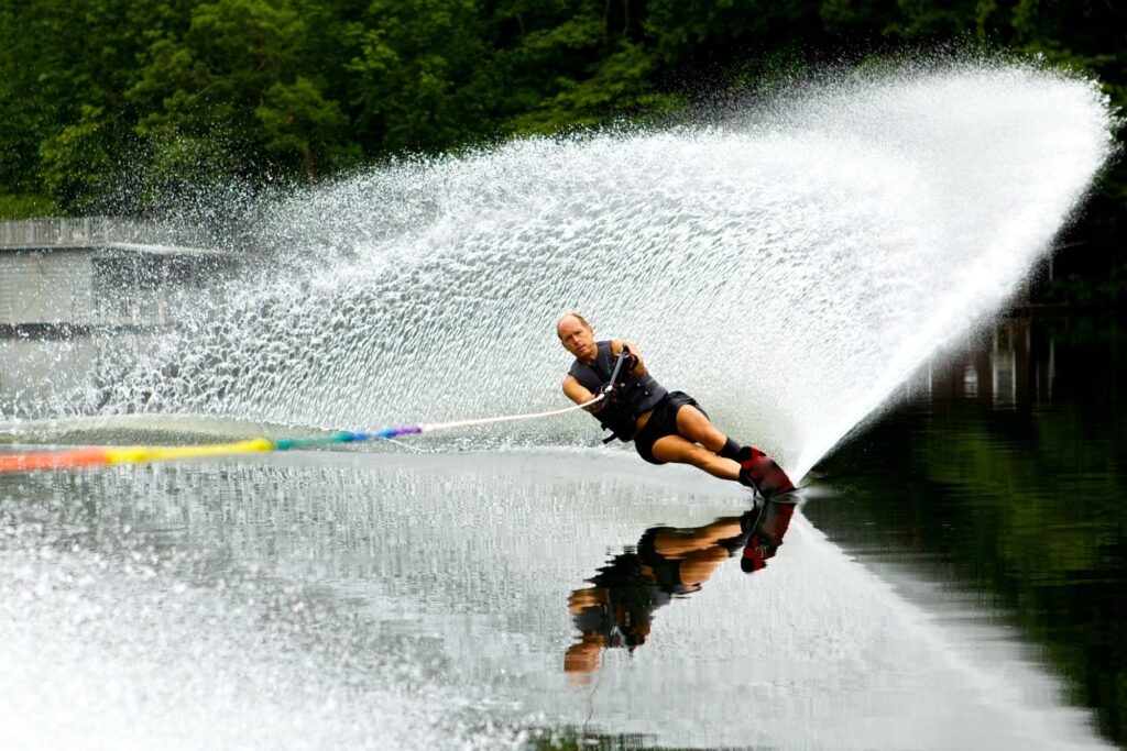 Active senior male water skiing in a small water passage