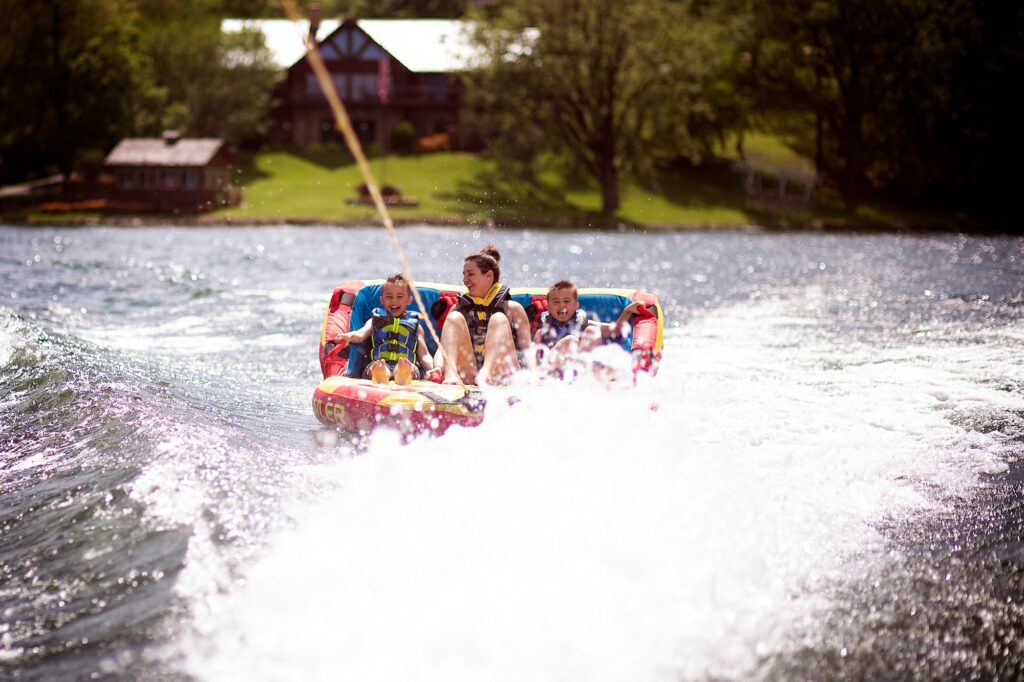 Mother and sons lake tubing having fun