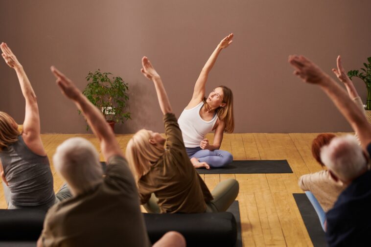 People exercising during yoga class