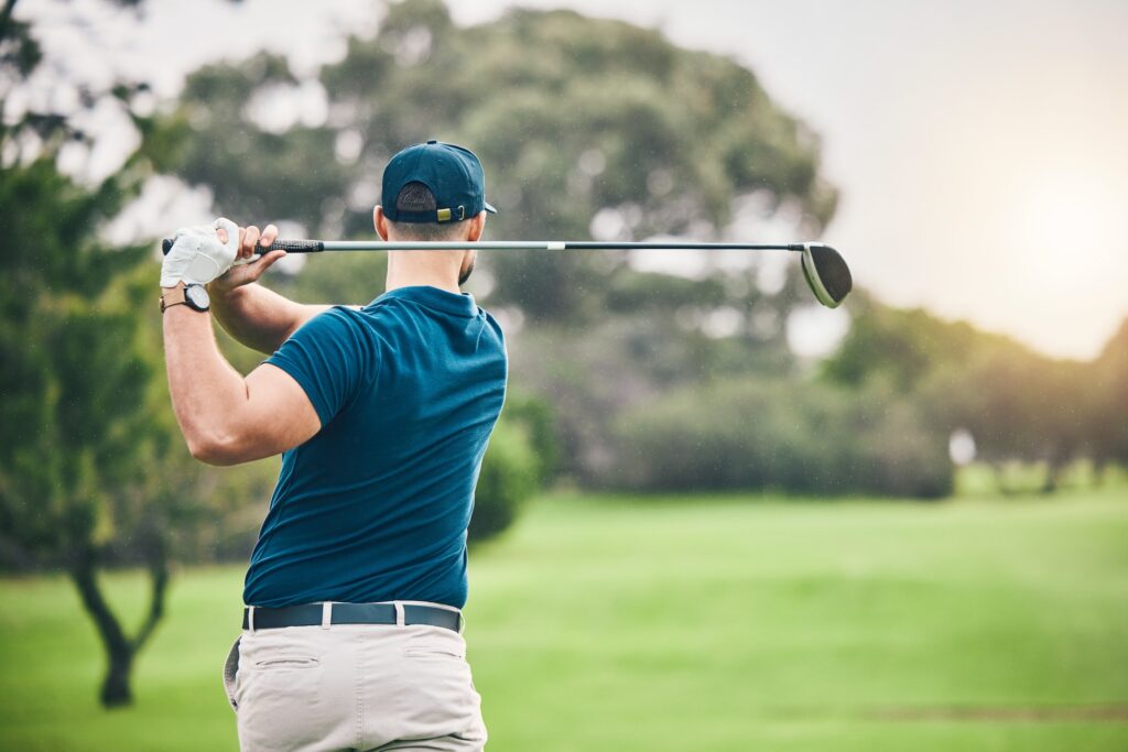 Sports, golf and man swing driver on field for exercise, training or workout match. Fitness, golfin